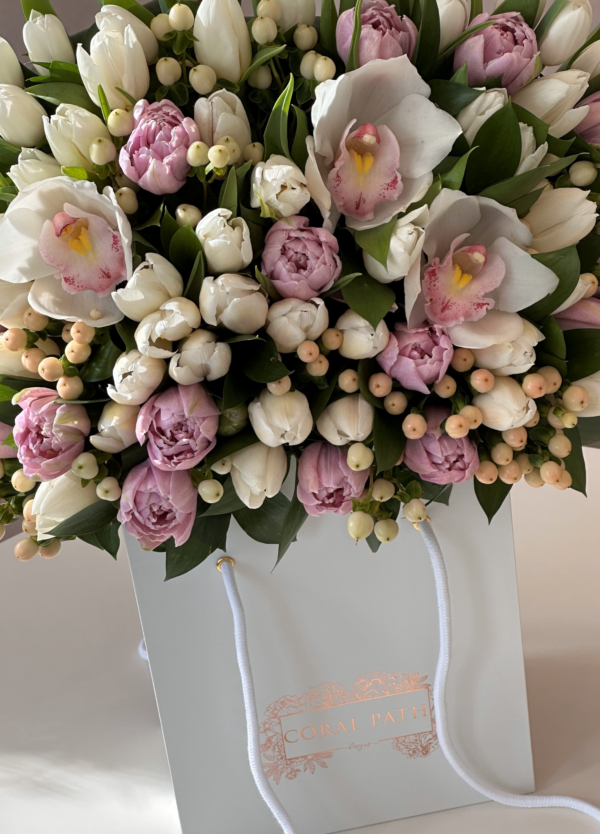 White and Purple Tulips, White Hypericums, and Cymbidium orchids arranged in a flower bouquet.