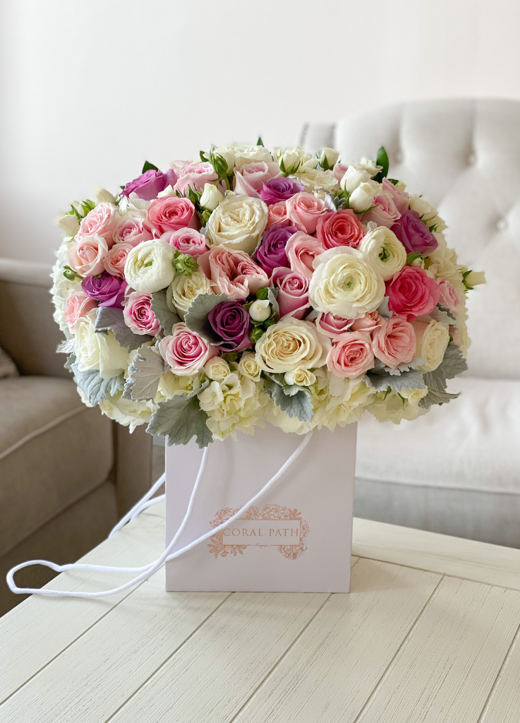Popular Girl arrangement featuring lovely hydrangeas and pops of Muave Roses and Dusty Miller.